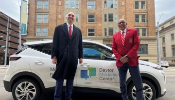 Photo of Dayton Commissioners and a city EV