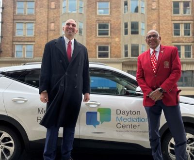 Photo of Dayton Commissioners and a city EV