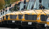 Photo of a row of Highland electric schools buses